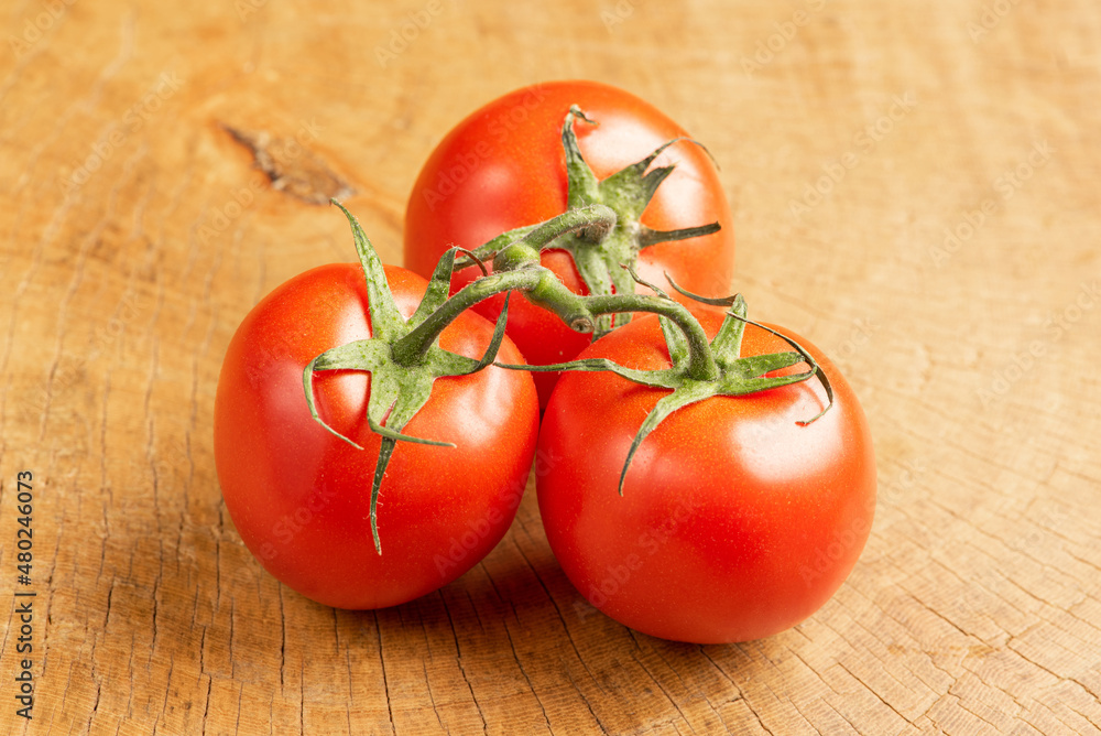 Tomatoes, beautiful tomatoes arranged over rustic wood, selective focus. Tomatoes, beautiful tomatoes arranged over rustic wood, selective focus.