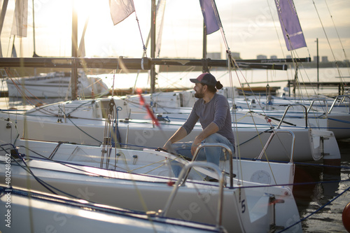 Preparation for the regatta at the yachting school at the marina with sailing yachts.