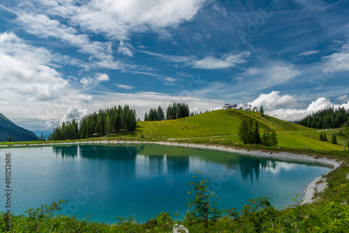 Nice blue green lake on big mountains in Austria summer cloudy day