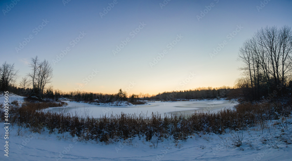sunset panorama over a frozen pond sunset panorama over a frozen pond
