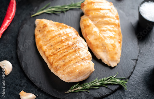 Photos grilled chicken breasts on stone background