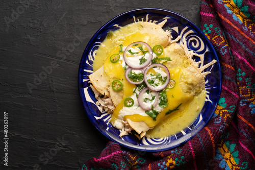Mexican green enchiladas with chicken and melted cheese