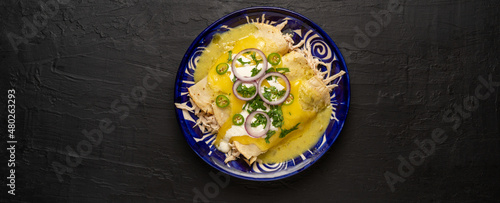 Mexican green enchiladas with chicken and melted cheese