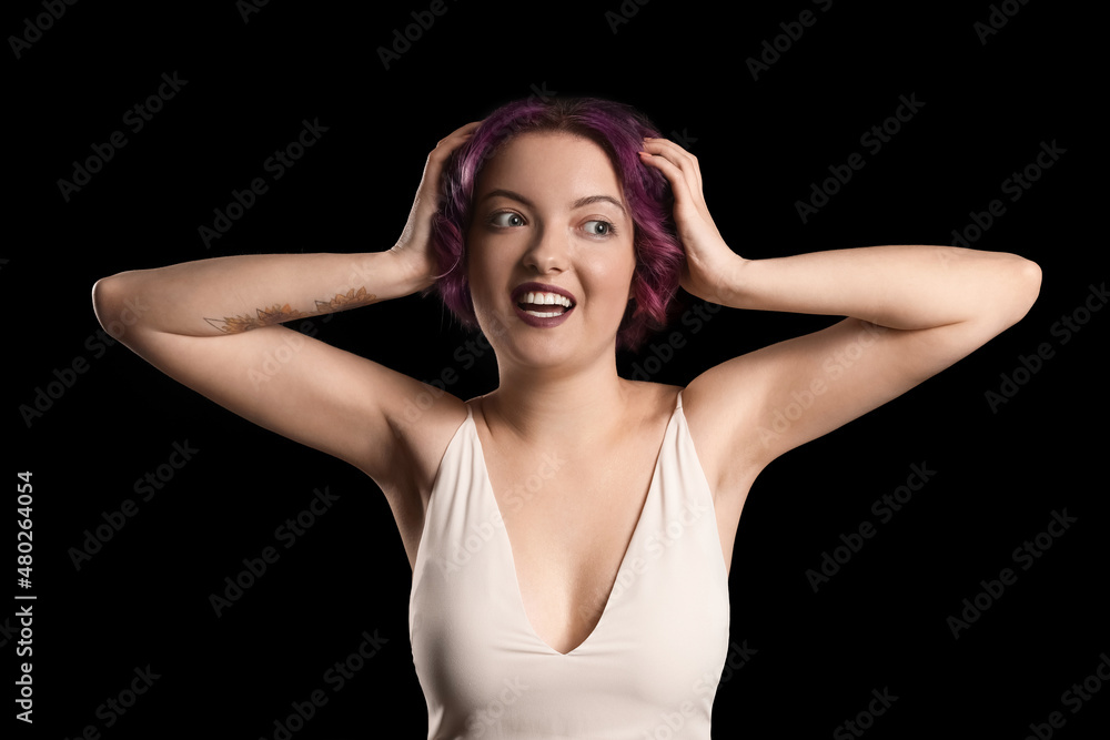 Portrait of attractive young woman with unusual hair on black background