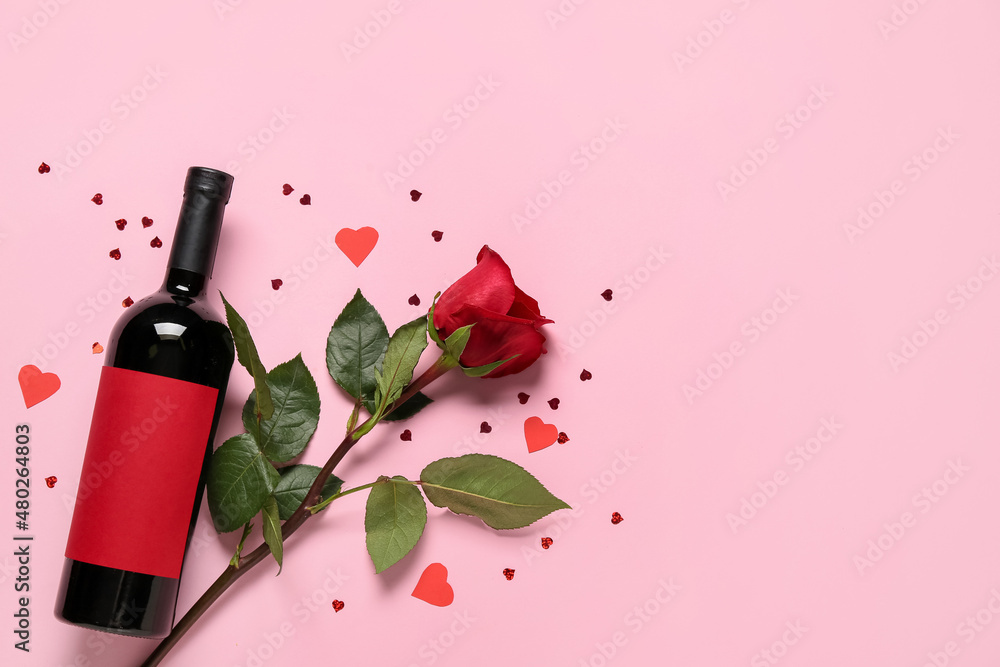 Bottle of wine and rose for Valentine's Day on pink background Stock