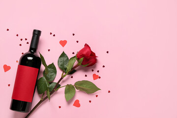 Bottle of wine and rose for Valentine's Day on pink background