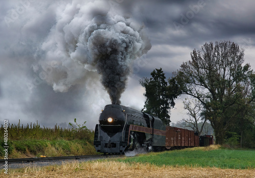 An Antique Restored Steam Freight Train Approaching Head on Blowing Smoke and Steam