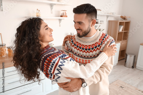 Happy young couple dancing at home