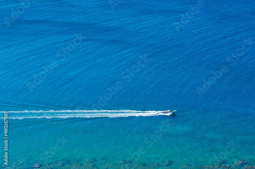 Aerial view of a speedboat traveling in the coastal area