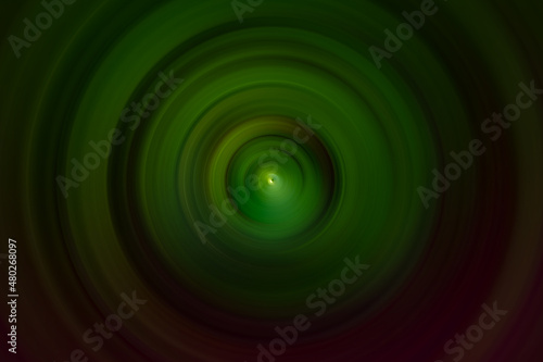 Dark green and red radial blur with light in the center