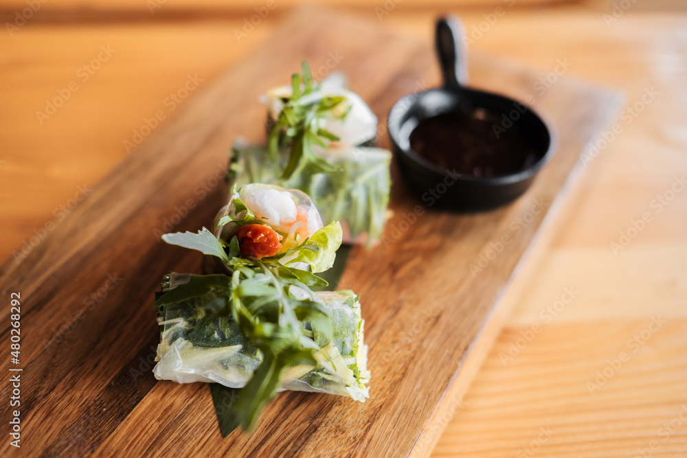 Spring rolls with shrimp, wooden chopsticks and soy sauce. Asian cuisine. Spring rolls with shrimp, wooden chopsticks and soy sauce. Asian cuisine.
