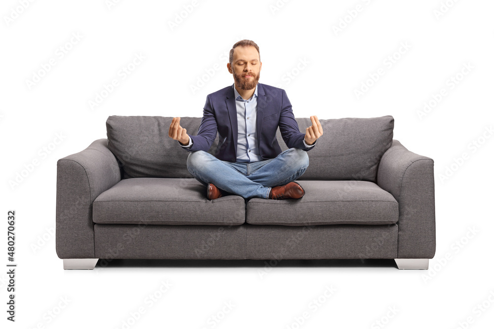 Young man meditating on a sofa Young man meditating on a sofa