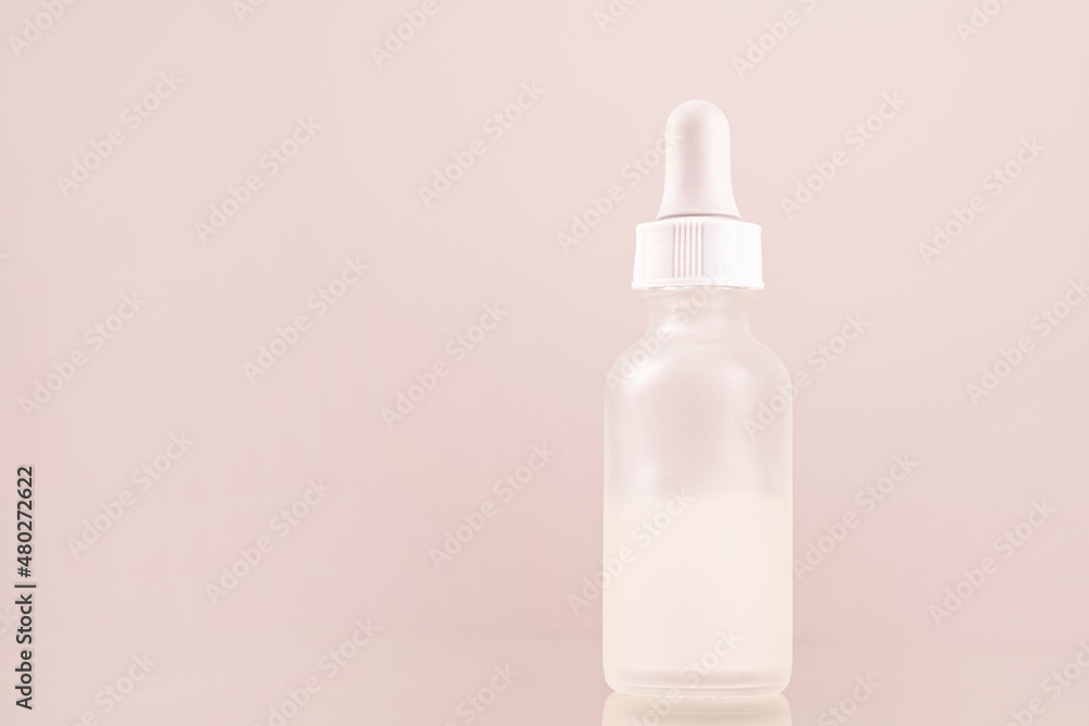 face serum oil dropper glass bottle with pipette on pink background close up face serum oil dropper glass bottle with pipette on pink background close up