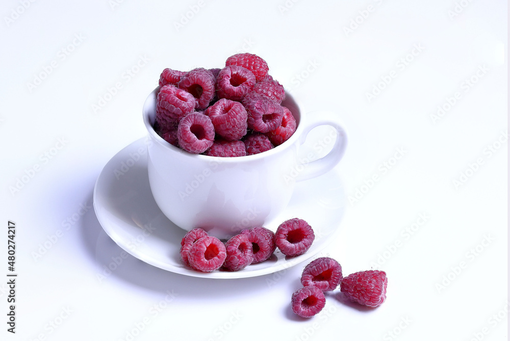 fresh raspberries in white cup sitting on the table, white background fresh raspberries in white cup sitting on the table, white background