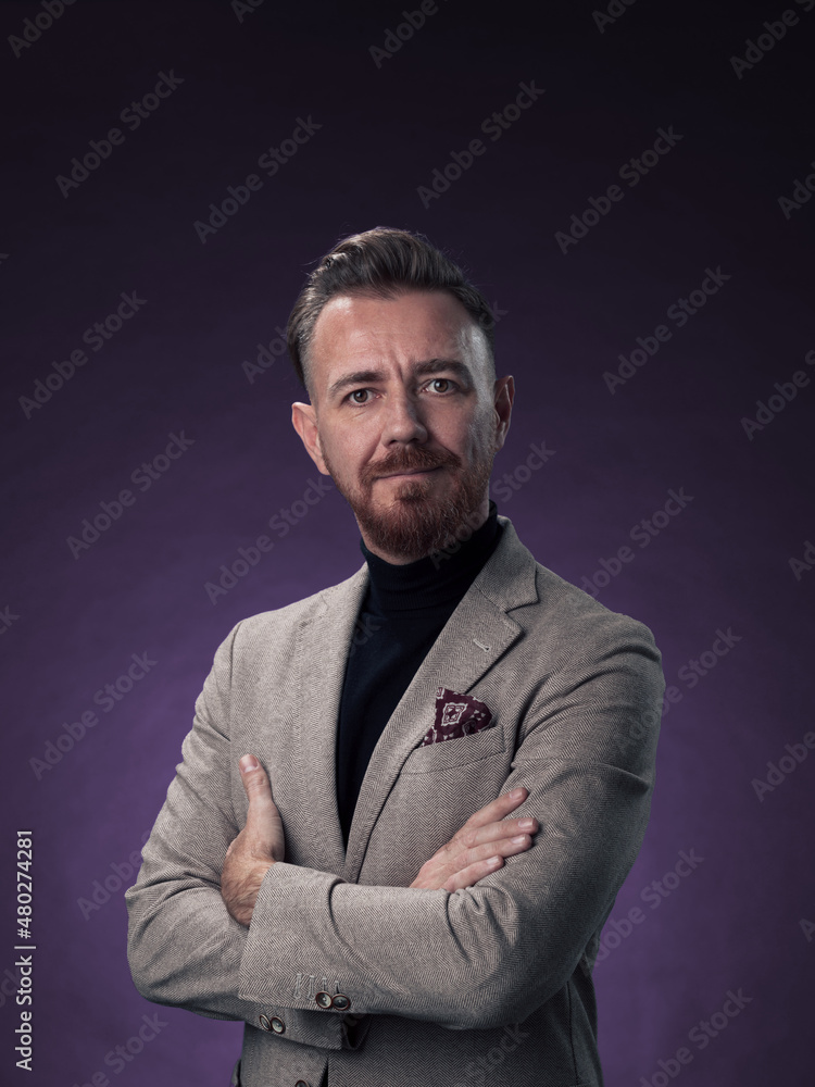 Portrait of a stylish elegant senior businessman with a beard and casual business clothes in photo studio isolated on dark background gesturing with hands Portrait of a stylish elegant senior businessman with a beard and casual business clothes in photo studio isolated on dark background gesturing with hands