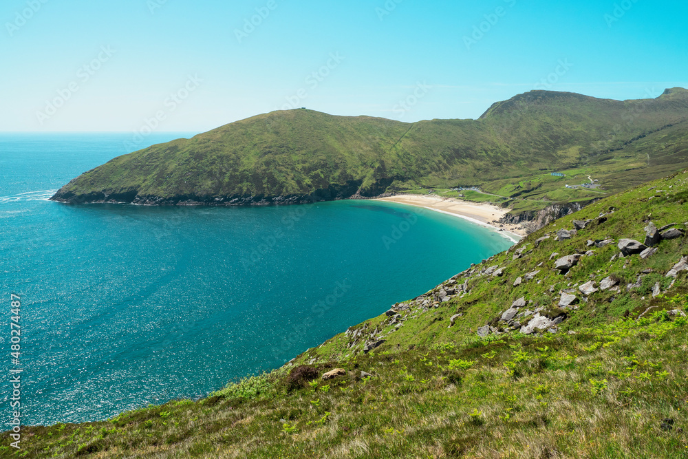 Picturesque nature scene with blue ocean, sky and sand beach, Keem bay and beach, Achill island, Ireland, Warm sunny day. Popular travel destination with amazing nature scenery.