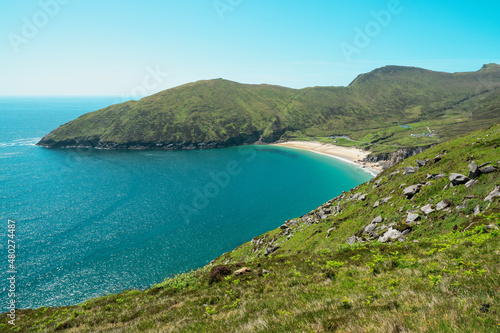 Picturesque nature scene with blue ocean, sky and sand beach, Keem bay and beach, Achill island, Ireland, Warm sunny day. Popular travel destination with amazing nature scenery.