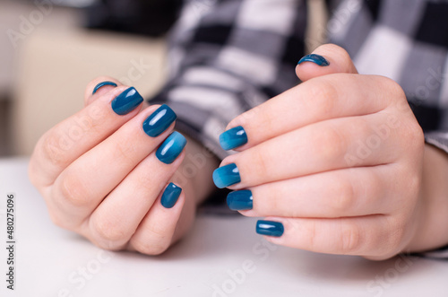  Beautiful female hands with ombre manicure nails  blue gel polish