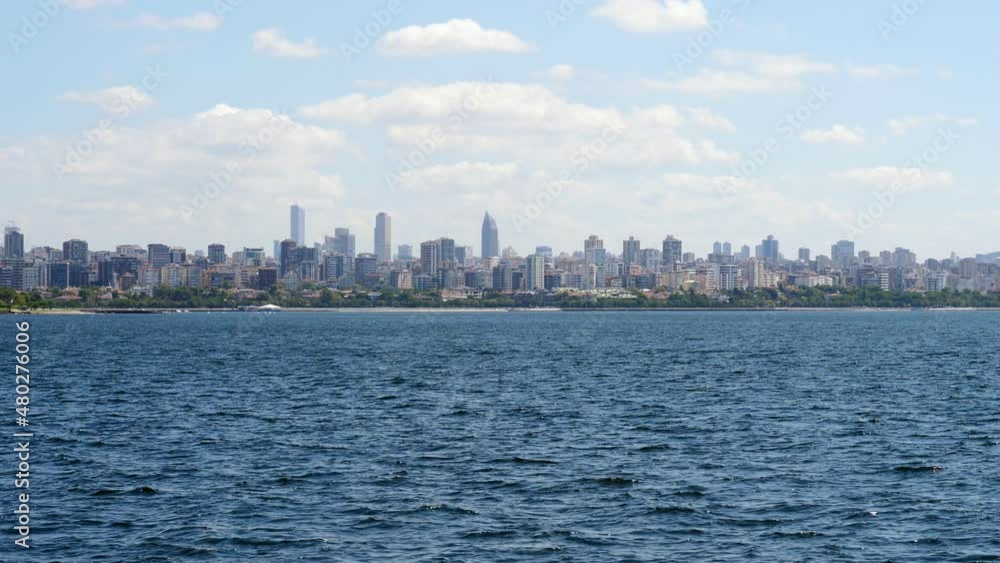 Shore of the Asian side of Istanbul and the dense residential development, view from a boat sailing to Prince Islands. Green parks and beaches seen along city coast Shore of the Asian side of Istanbul and the dense residential development, view from a boat sailing to Prince Islands. Green parks and beaches seen along city coast