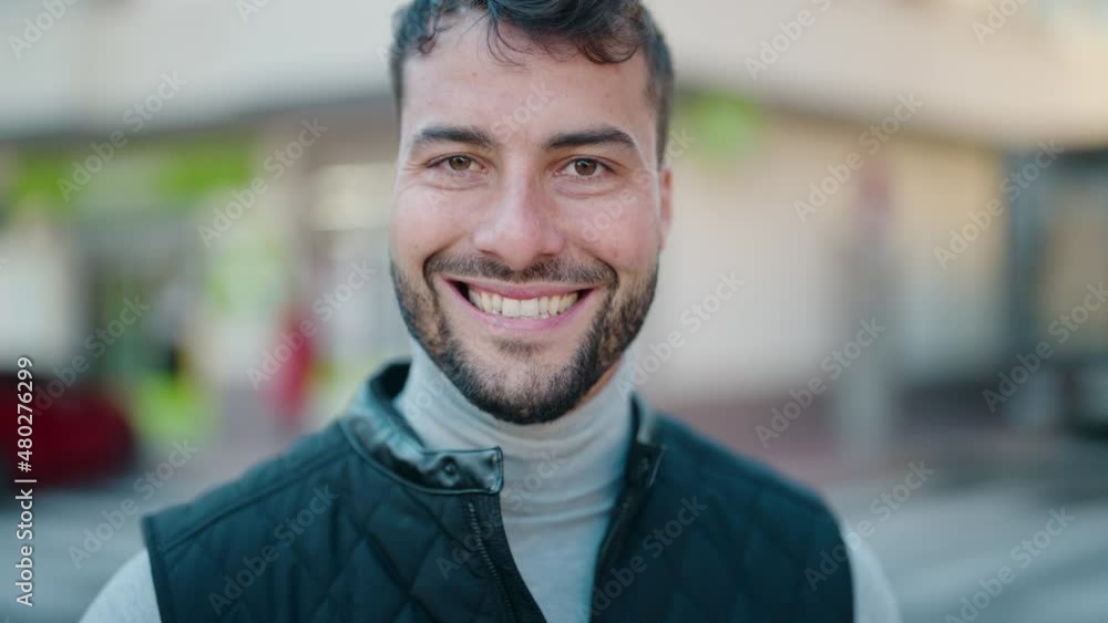 Young hispanic man smiling confident standing at street Young hispanic man smiling confident standing at street