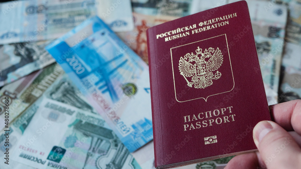 Russian passport on background with Russian rubles. - obrazy, fototapety, plakaty 