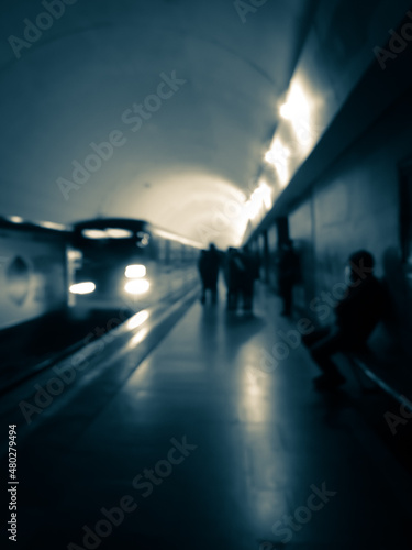 Blurred human silhouettes waiting for the train