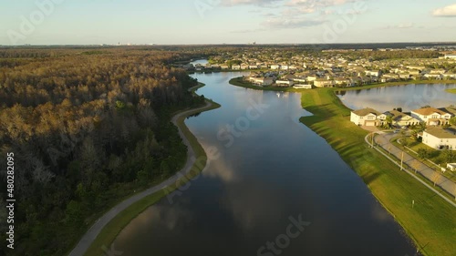 View from the heights of a lake with surrounding forests, houses and bike paths in Kissimmee, a city in Osceola County, just south of Orlando. photo