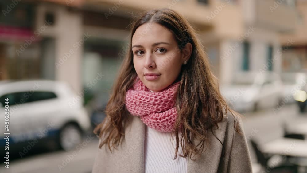 Young woman standing with relaxed expression at street Young woman standing with relaxed expression at street