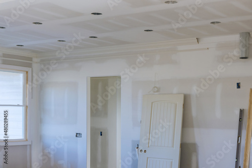 Plastering drywall new home industry on finishing putty in the room walls plasterboards with room under construction photo