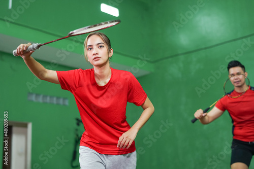 Female badminton player ready to hold the racket