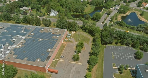 Aerial panoramic overview of solar system on a roof building warehouse an industrial zone ner American countryside small town photo