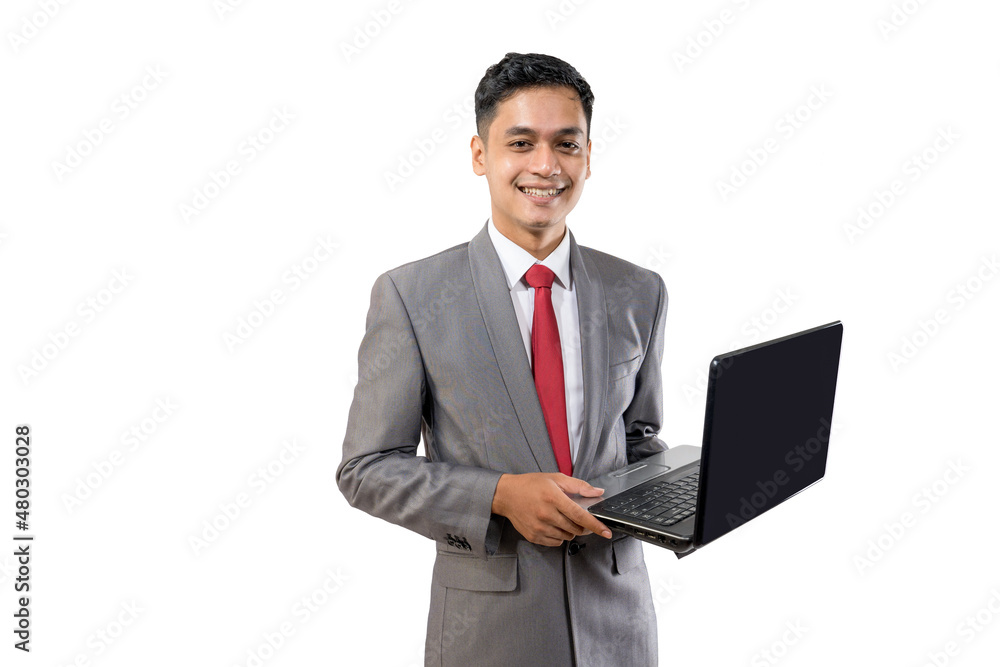 business young asian man holding a laptop while standing isolated over white business young asian man holding a laptop while standing isolated over white