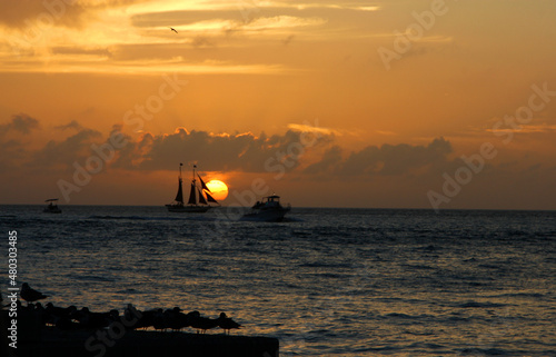 A boat in the ocean at sunset photo