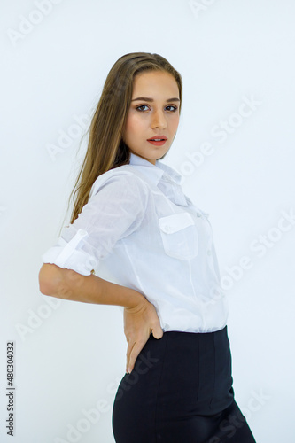 Portrait isolated studio cutout shot of Caucasian young beautiful long brunette hair female businesswoman employee in casual business outfit standing smiling look at camera posing on white background