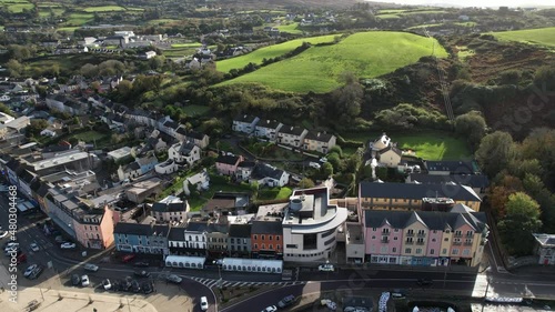 Bantry, County Cork Ireland. Aerial view of buildings by bay and green landscape on sunny day, establishing drone shot