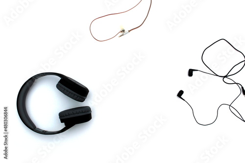 Large and small headphones lie on a white isolated background.