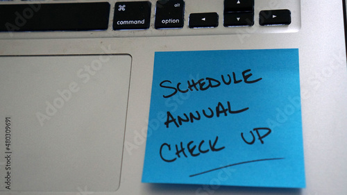 Sticky note reminder to schedule annual check up.