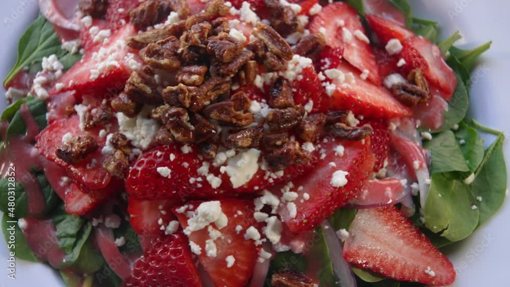 Strawberry spinach salad with blue cheese and candied walnuts, slider close up 4K Strawberry spinach salad with blue cheese and candied walnuts, slider close up 4K