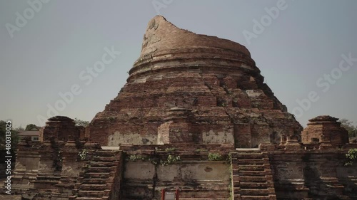 A tilt establishing shot of the spectacular Wat Kudi Dao Temple, one of the many beautiful temples in the Ayutthaya Kingdom in Thailand photo