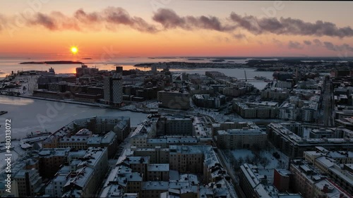 Aerial drone view over Hietalahti towards Jatkasaari, winter sunset in Helsinki, Finland photo