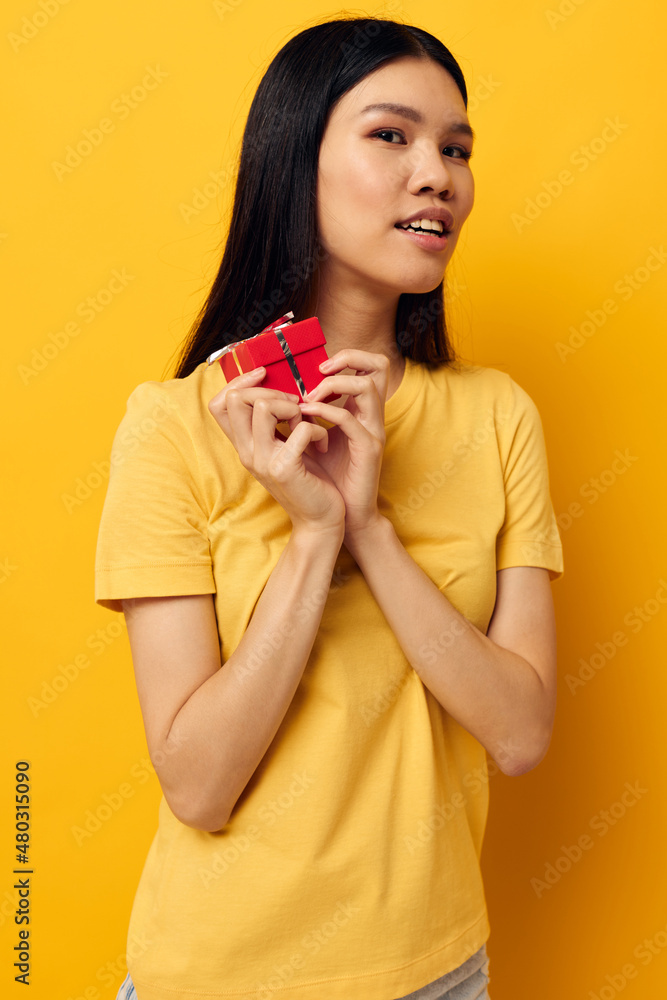 Portrait Asian beautiful young woman in a yellow t-shirt holiday gift emotions Lifestyle unaltered Portrait Asian beautiful young woman in a yellow t-shirt holiday gift emotions Lifestyle unaltered