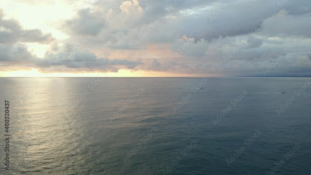 Two small boats headed to the harbour of Quepos, Costa Rica during sunset. Drone pulling backwards while panning. Colourful dramatic cloudscape illuminated by the warm low sun. Two small boats headed to the harbour of Quepos, Costa Rica during sunset. Drone pulling backwards while panning. Colourful dramatic cloudscape illuminated by the warm low sun.