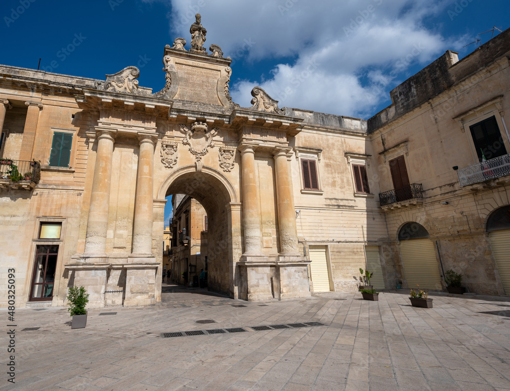 Lecce, Puglia, Italy. August 2021. View towards one of the access gates to the historic center. People enter and leave the old city through it. Beautiful summer day.