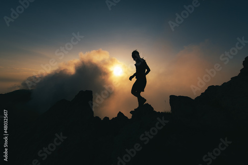 A man in silhouette walks a rocky ridge during a solitary meditation