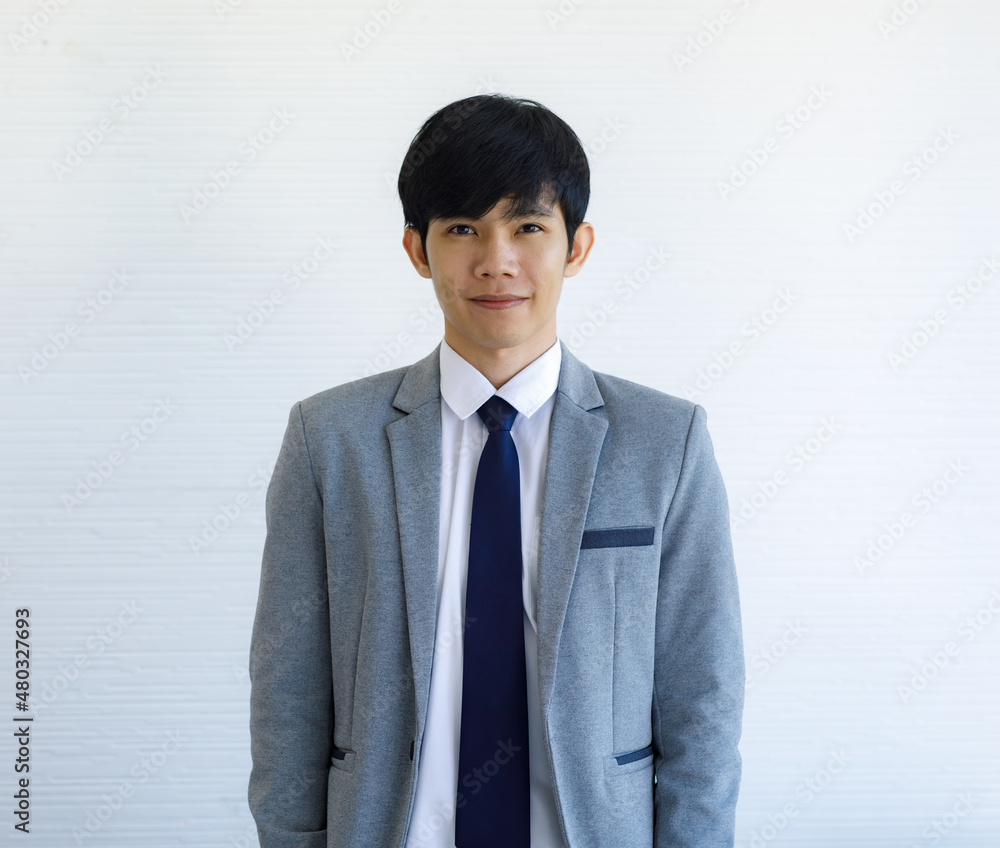 Portrait studio shot of Asian young happy handsome male groom in grey formal wedding suit standing crossed arms smiling look at camera in front white wall background. Millennial Asia businessman Portrait studio shot of Asian young happy handsome male groom in grey formal wedding suit standing crossed arms smiling look at camera in front white wall background. Millennial Asia businessman
