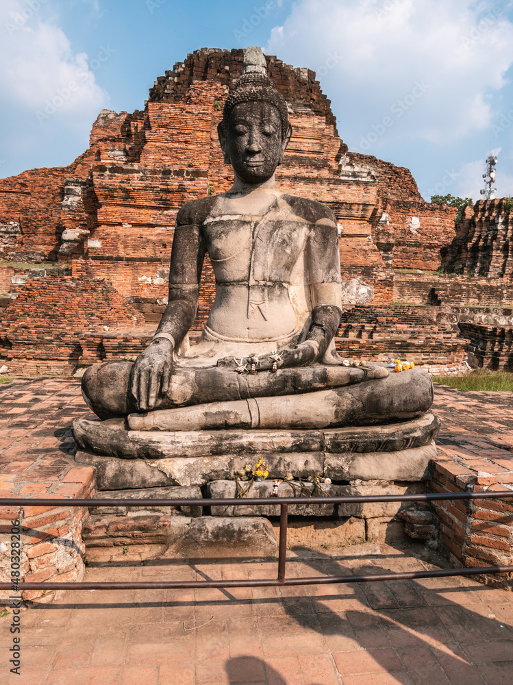 Sitting Buddha statue in Wat Mahathat (Temple of the Great Relic), ancient old pagoda or stupas in Ayutthaya, Thailand. Sitting Buddha statue in Wat Mahathat (Temple of the Great Relic), ancient old pagoda or stupas in Ayutthaya, Thailand.