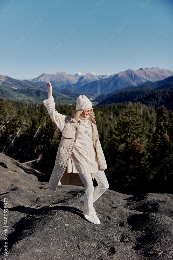 young woman standing on the top of the mountain forest relaxation young woman standing on the top of the mountain forest relaxation
