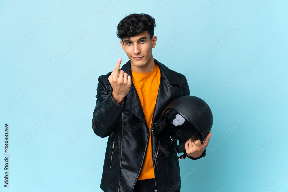 Argentinian man with a motorcycle helmet doing coming gesture Argentinian man with a motorcycle helmet doing coming gesture