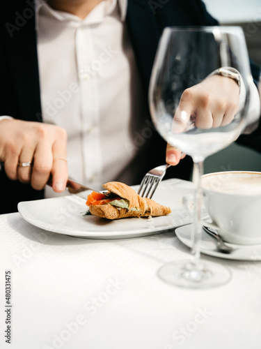 Fototapeta Naklejka Na Ścianę i Meble -  Businessman eating breakfast. Man eats oatmeal with fruits and nuts. Healthy breakfast