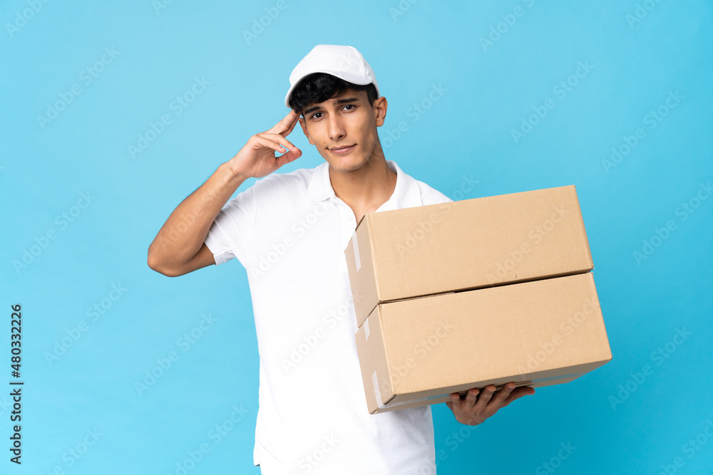 Delivery Argentinian man isolated on blue background having doubts and thinking Delivery Argentinian man isolated on blue background having doubts and thinking